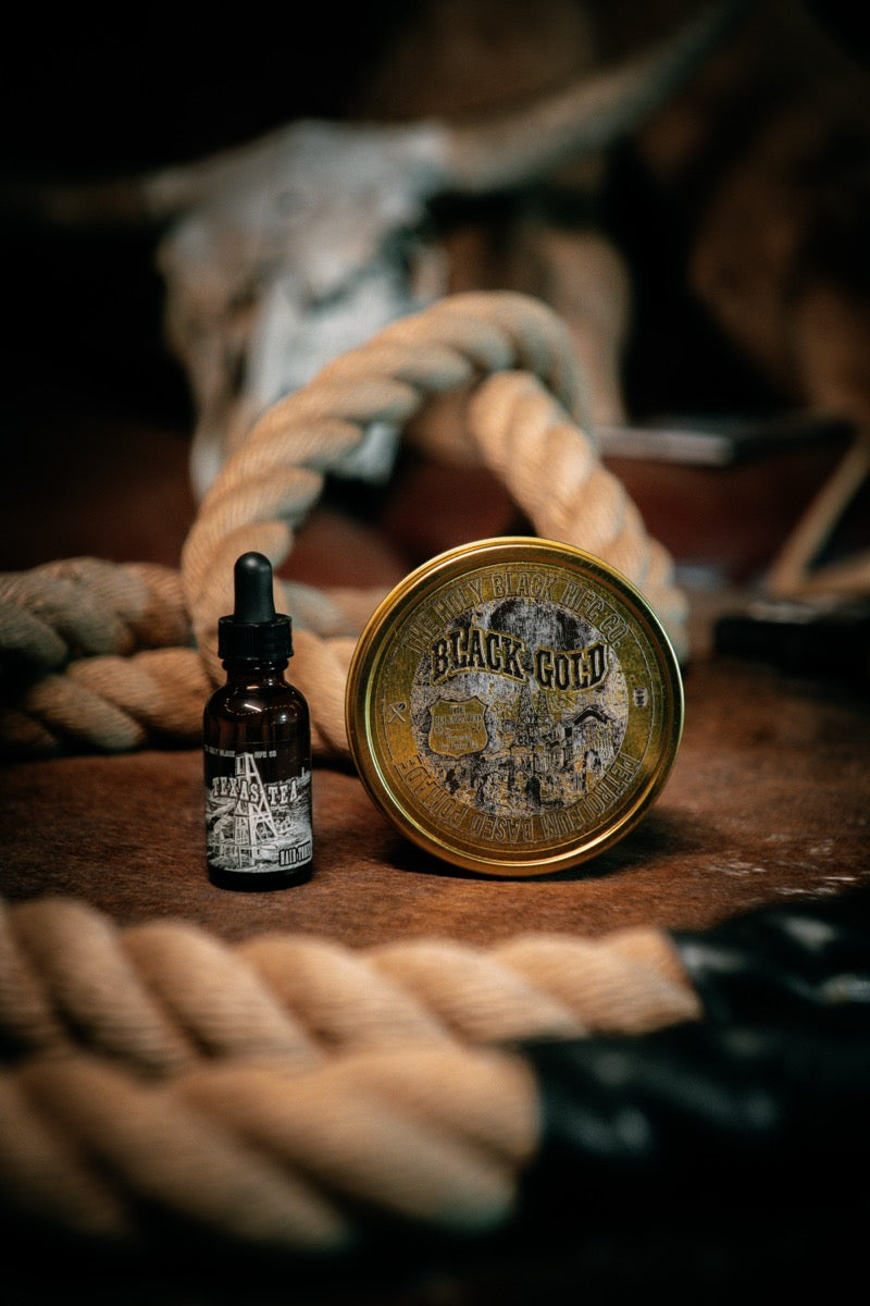 Holy Black beard oil with rope styling on rustic surface
